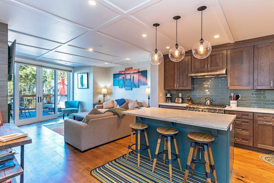 The spacious and open kitchen offers a generous natural stone island