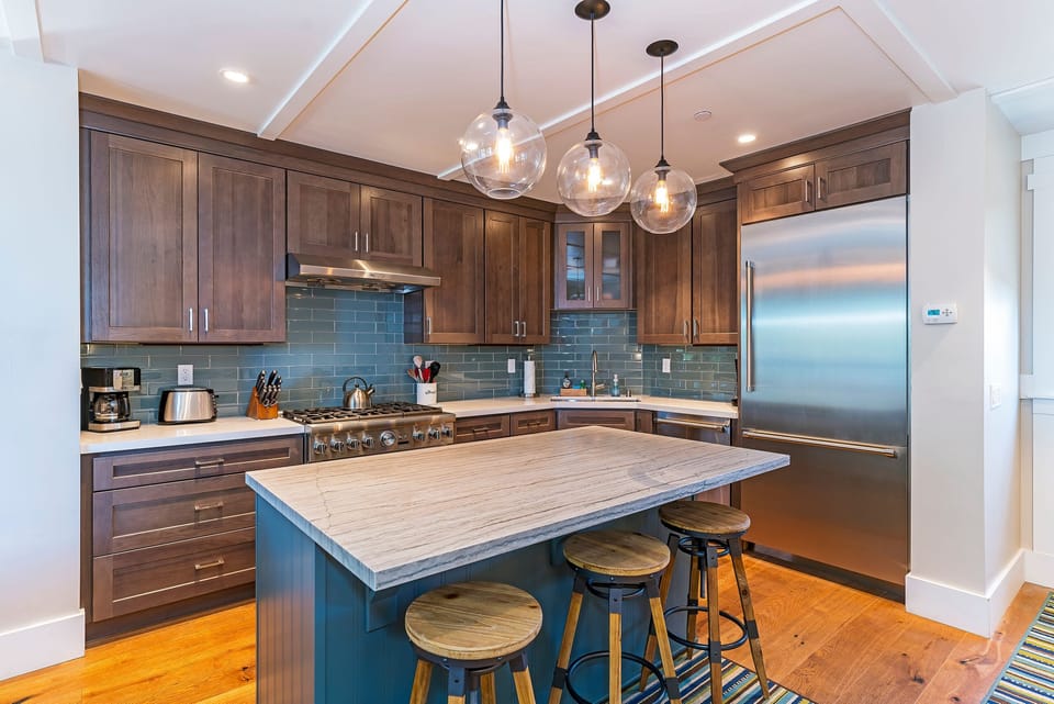 Natural granite, stone surfaces and wide plank hardwood floors