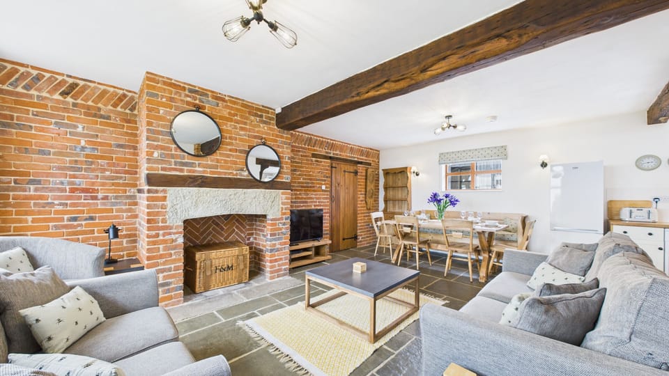 A bright and airy sitting area that blends rustic charm with modern comforts in an open-plan layout.