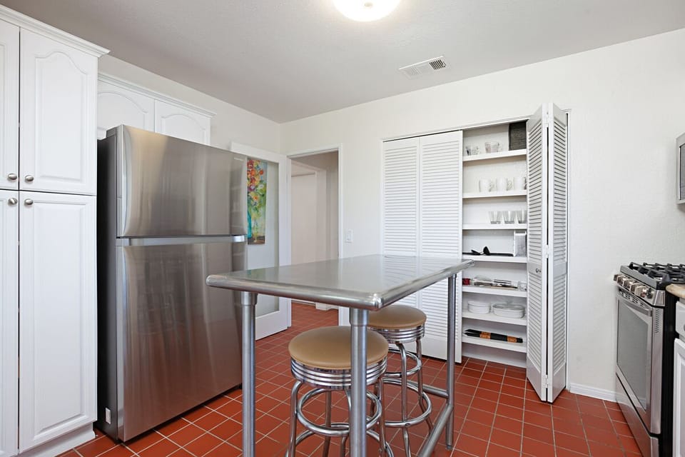 Full sized fridge, vitamix, kitchenaide, toaster, steamer and gadgets.