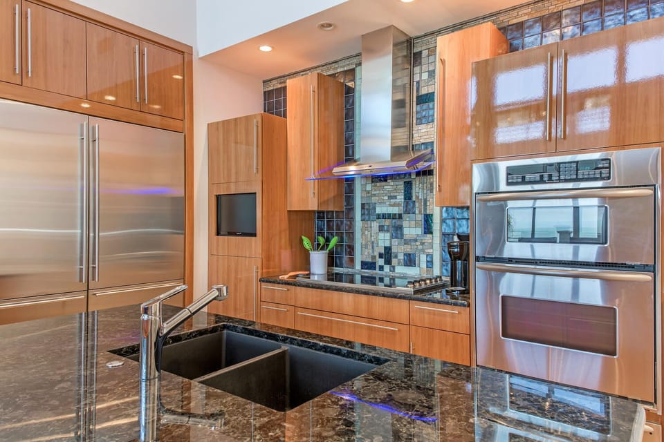 Kitchen Close up of Cooktop, double ovens and professional refrigerator 