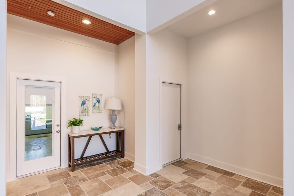 Foyer Entrance from street side - entrance to game room/den and out to the pool