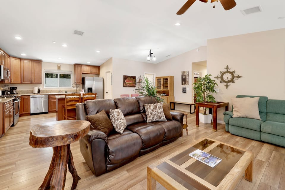 Cozy mountain living room with a stone fireplace, comfy seating, and smart TV—perfect for relaxing evenings, movie nights, and warm cabin vibes after outdoor adventures.