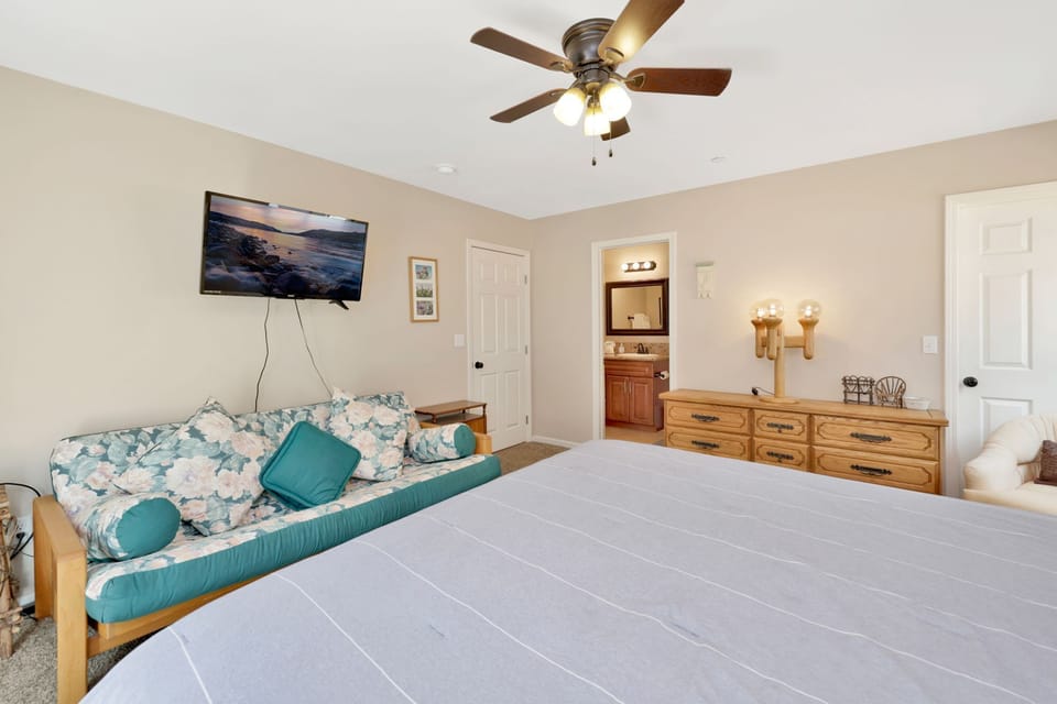 Peaceful cabin bedroom with plush bedding, and beautiful views—ideal for restful nights, cozy mornings, and a relaxing mountain escape.