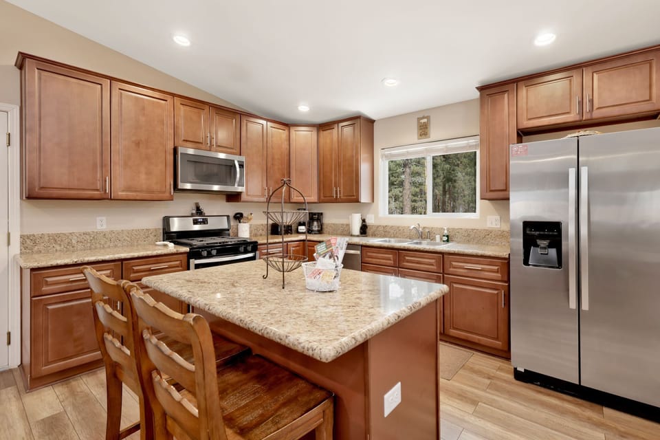 Fully equipped cabin kitchen with ample cabinetry, stove, fridge, microwave, and coffee maker—perfect for cooking meals, morning coffee, and feeling right at home on your stay.