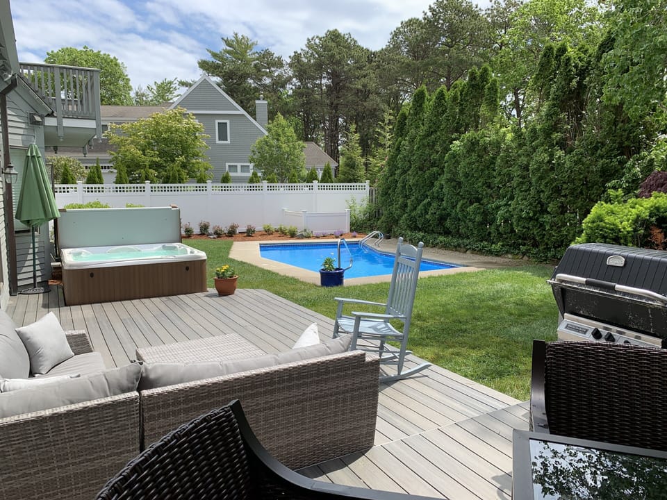 Full View of the private yard with gas grill, hot tub, pool, and room to relax