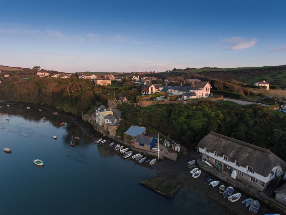 The quaint pretty quayside and fishermen's boathouses of Bantham