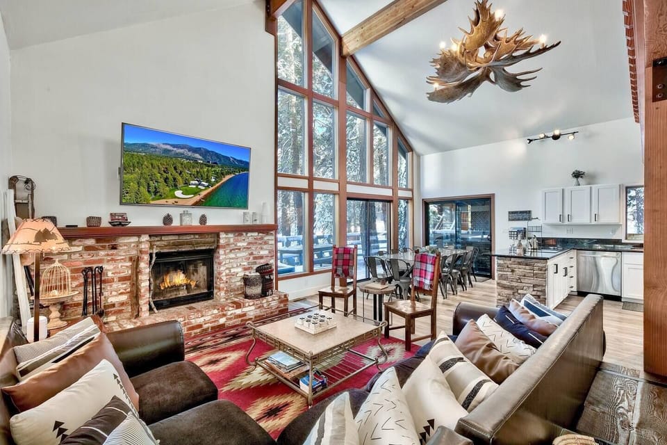Our living room features an open layout that flows into the dining room, kitchen, and back deck. Enjoy massive windows, a smart TV, free WiFi, and a cozy wood-burning fireplace (just bring your own firewood!)