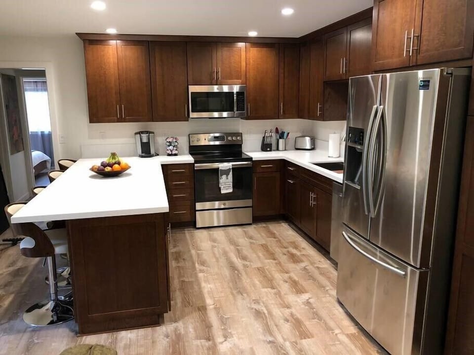 View of kitchen with island counter and counter seating for four