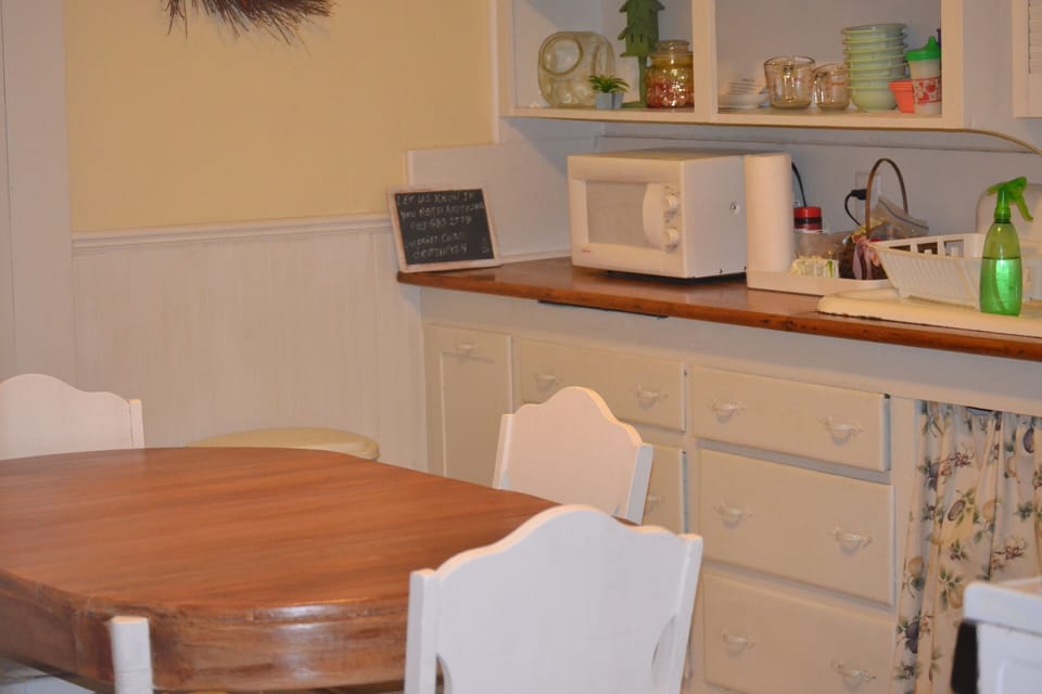 Dining Area in Kitchen with Microwave,  Stove, Refrigerator and Coffeemakers
