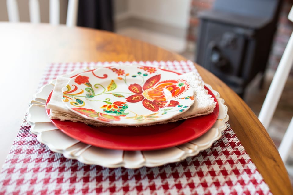 Plates for dining and a small wood-stove in the living room.
