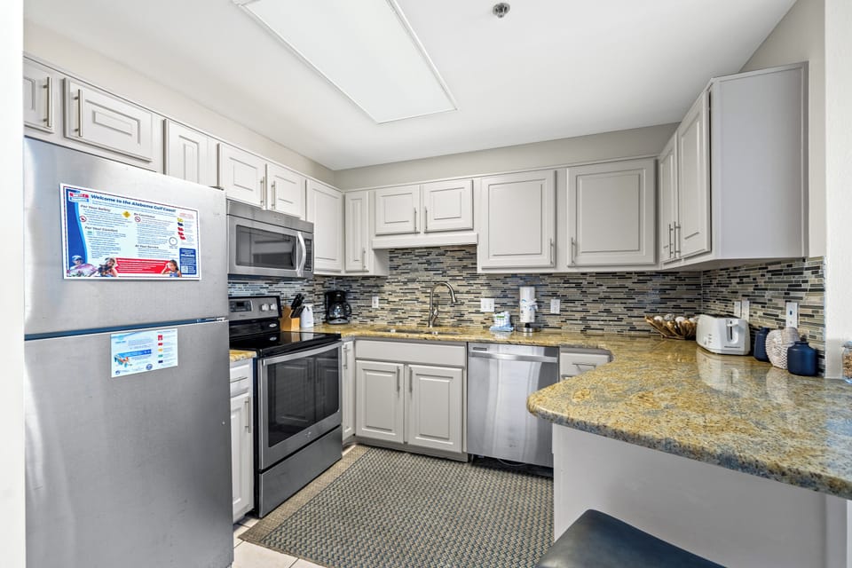 The modern kitchen features sleek cabinetry, a stylish countertop, and a convenient breakfast bar for casual dining