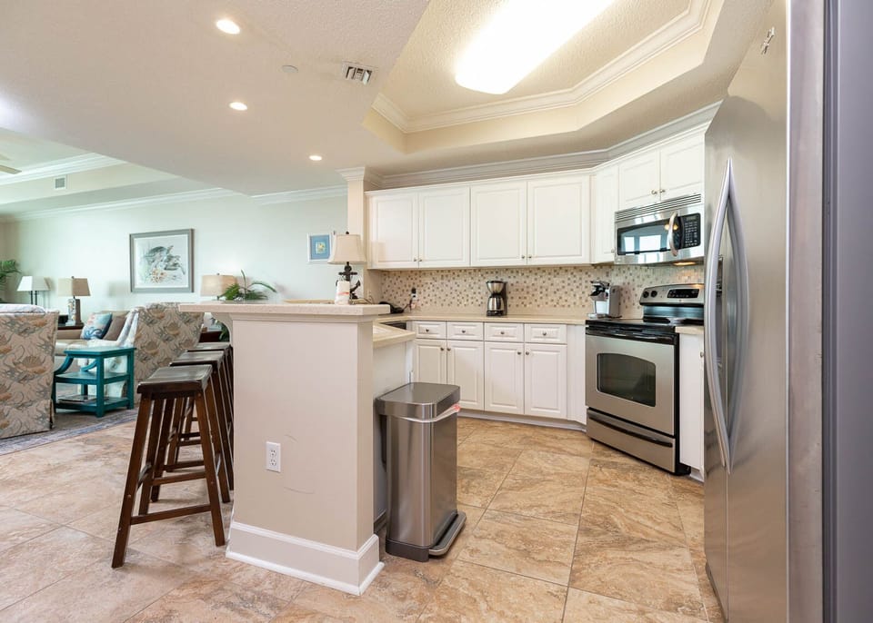 Prepare meals in this kitchen with elegant cabinetry, stainless appliances, and spacious countertops