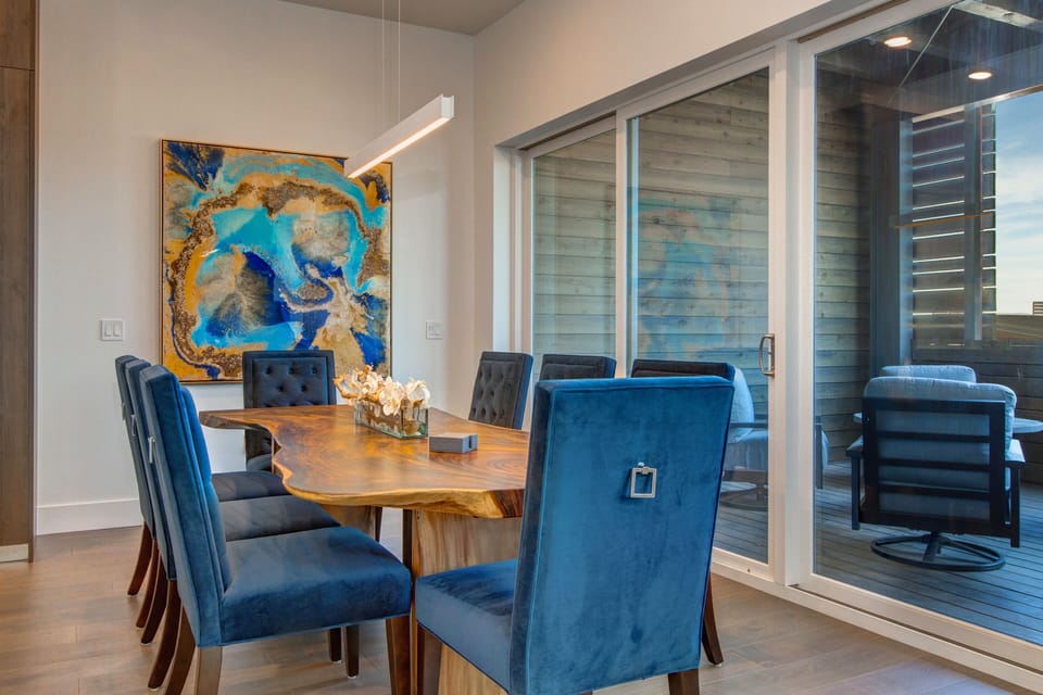Dining Area with a Stunning Wood Table, Comfortable Chairs and Deck Access