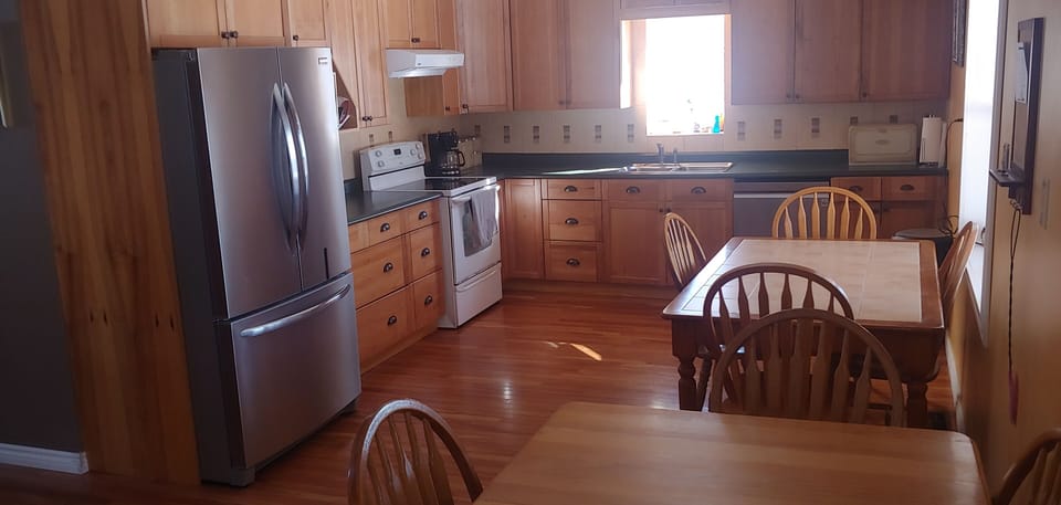 Large kitchen and fully stocked with utensils.