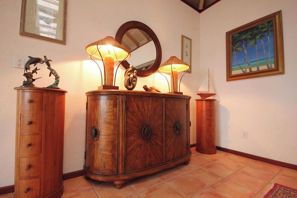 Elegant teak and mahogany furniture is found throughout the house