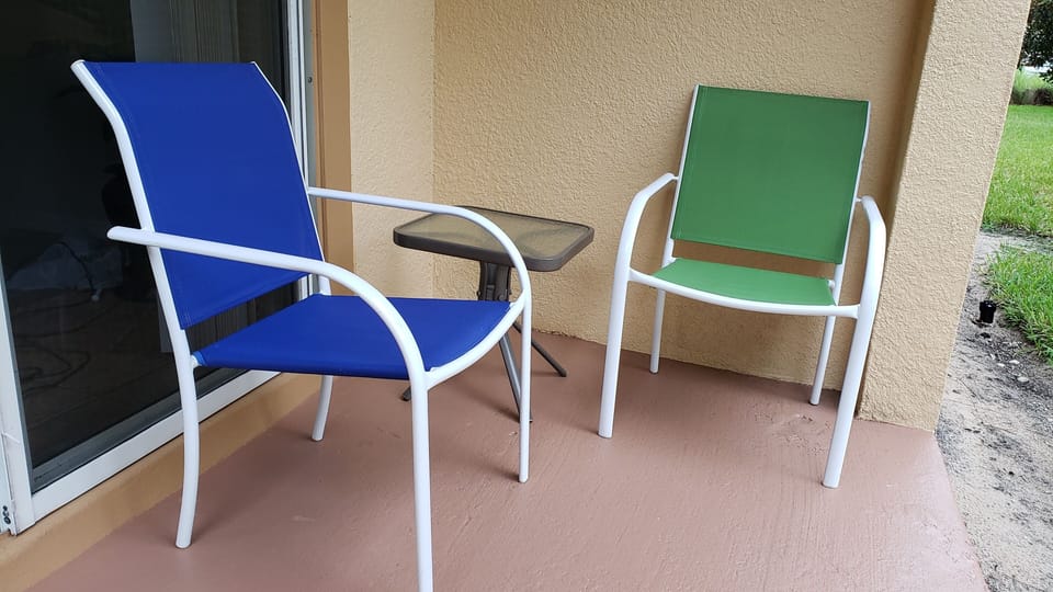 Back porch seating. Backyard is open and shared with friendly neighbors.