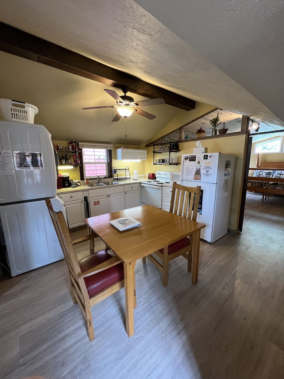 Fully stocked kitchen with refrigerator, oven.