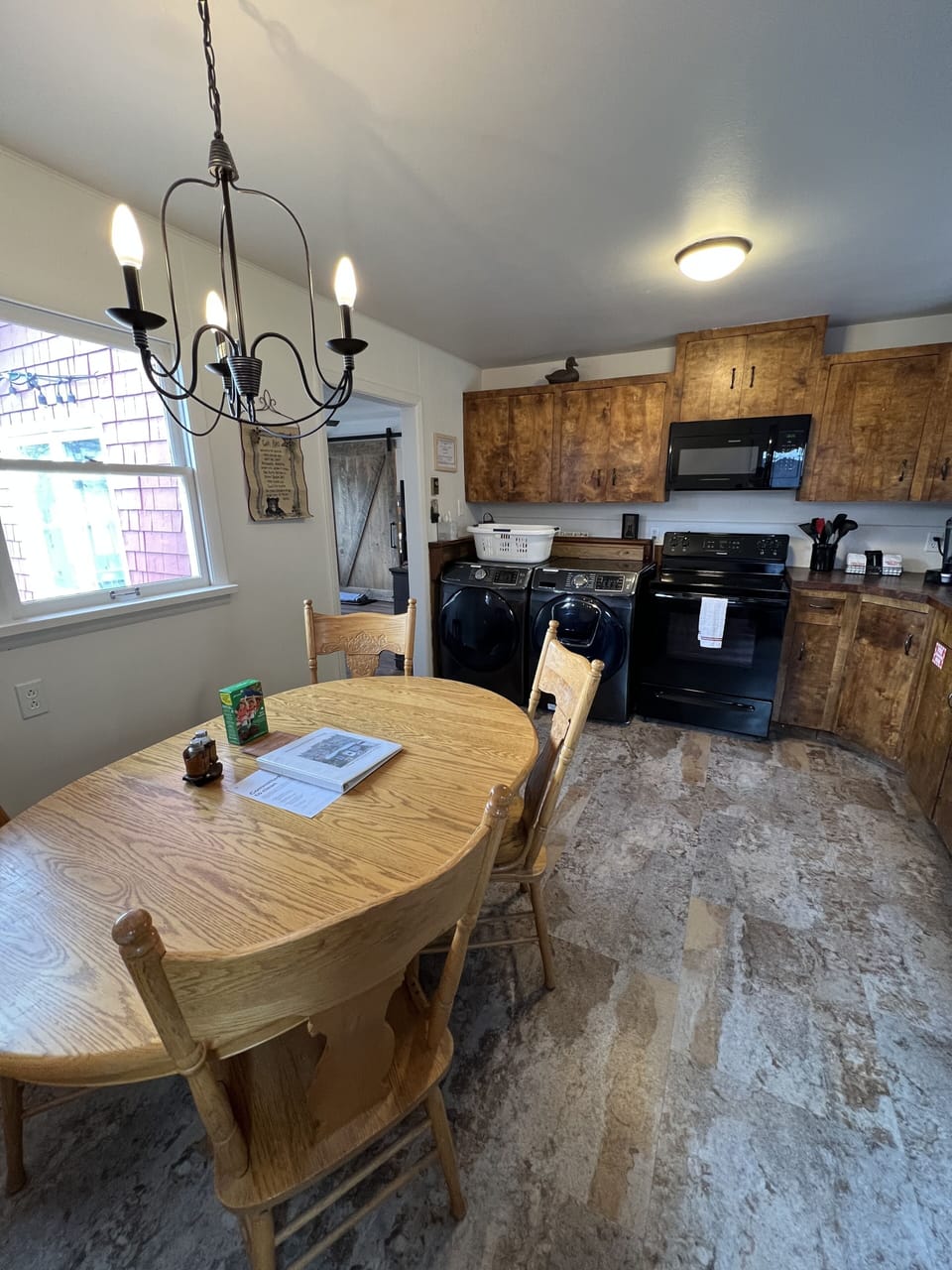 Full size washer and dryer in kitchen.  Table with leaf.