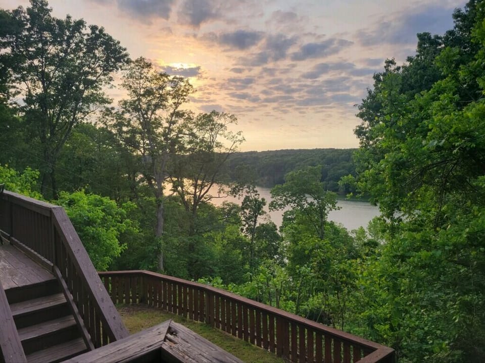 Unwind on your private deck overlooking lush greenery and a tranquil river.