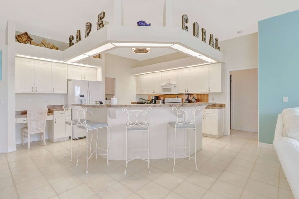 The open kitchen features an eating bar with bar stool seating - great for quick meals and entertaining.