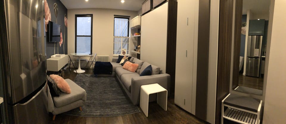 Murphy bed behind sofa. 
Pulls down on top of sofa.   Nothing needs to be moved
