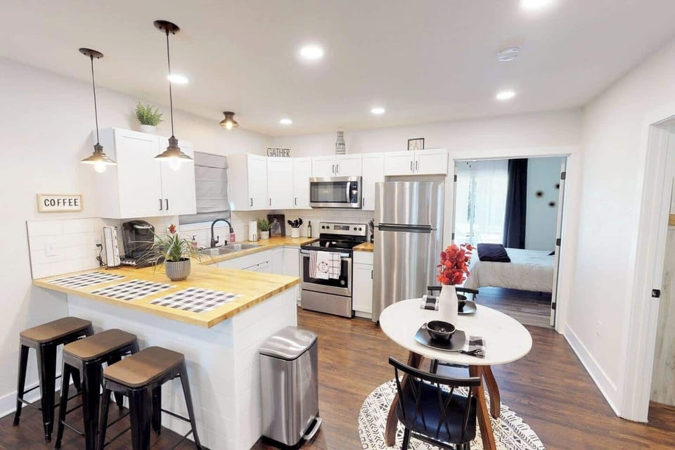Kitchen with new stainless steel appliances and bar that seats up to 4;  Beautiful marble dining table