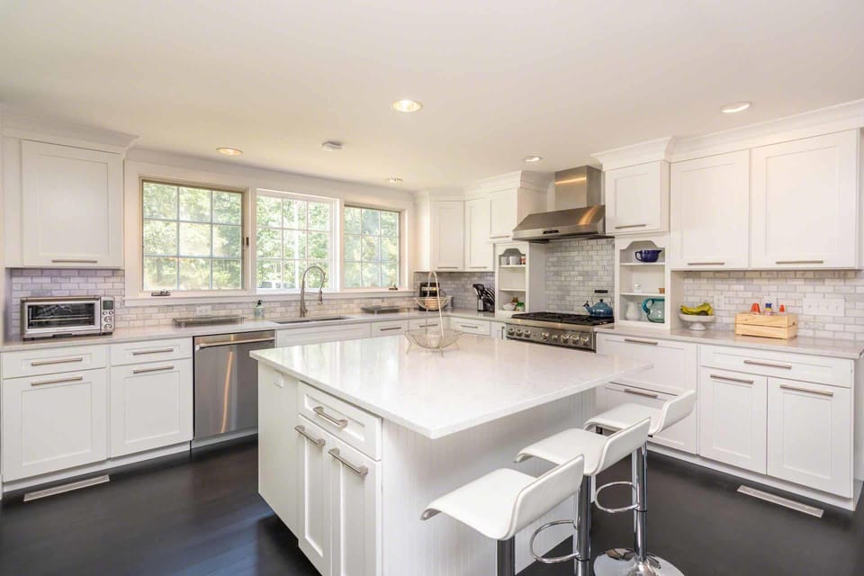 Fully Equipped Kitchen Has Center Island and Marble Counters