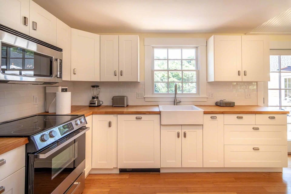 Kitchen Has Farmers Sink and Overlooks the Backyard, Deck and Pool