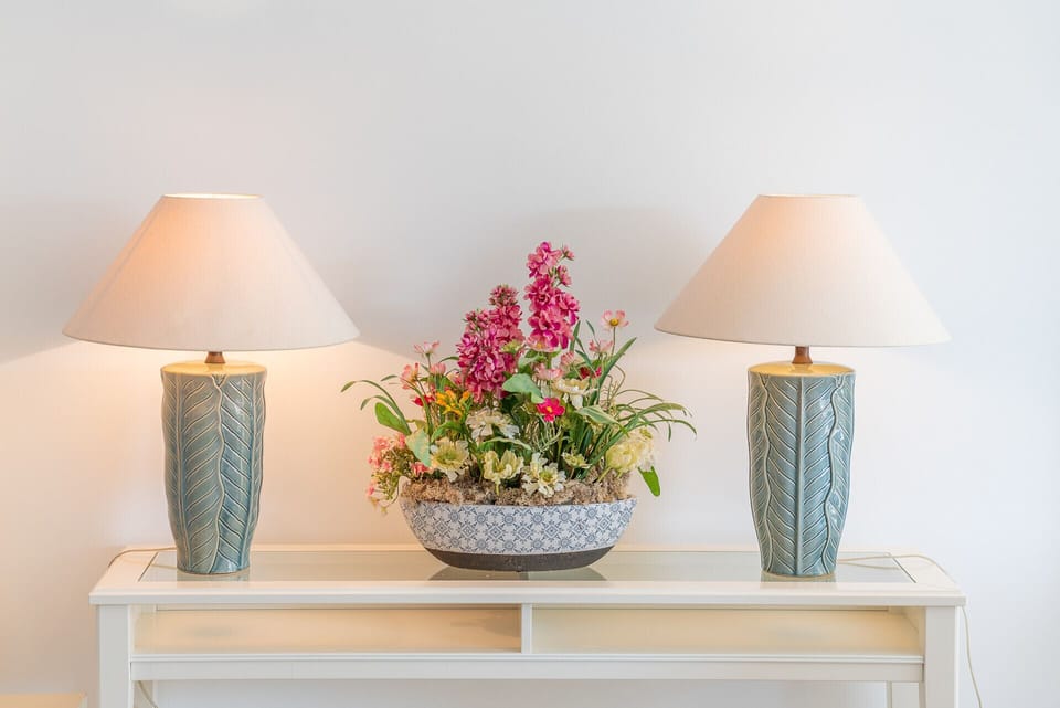 Elegant bedroom console with matching table lamps and fresh flower arrangement — Villa del Rey VII, holiday villa in Óbidos