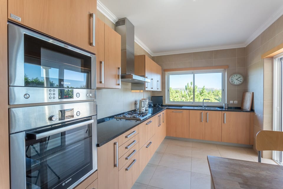 Modern kitchen with stainless steel Bosch appliances — Villa del Rey VII, luxury holiday villa in Óbidos