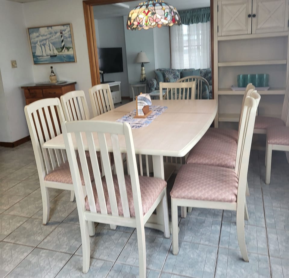 Lower-level kitchen has food storage cabinet and bar