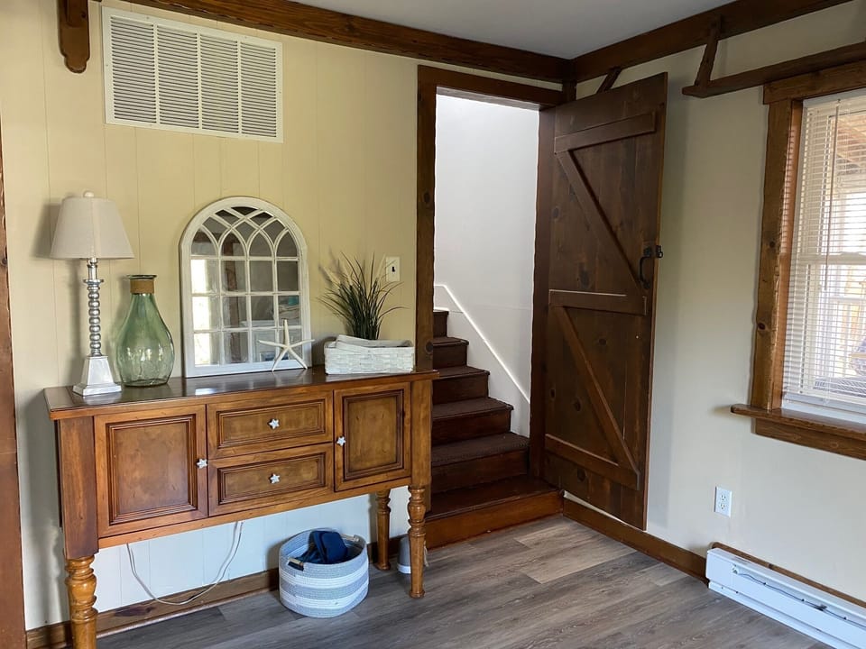 Den and stairs to the third floor where the four bedrooms are located