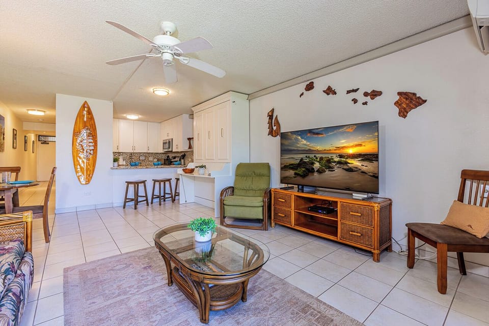 Thoughtfully designed for convenience, this bright kitchen area features bar seating, ample cabinetry, and a built-in workspace—perfect for meal prep, remote work, or planning your next island adventure.