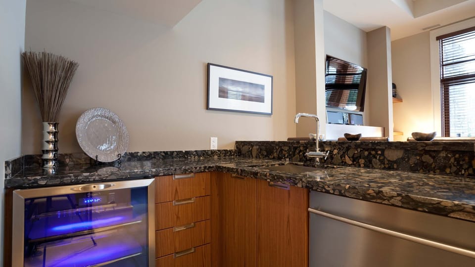 - Granite wet bar with wine fridge and sleek cabinetry for entertaining  
- Perfect for mixing cocktails or storing après-ski refreshments  
- Sophisticated touch blending style and function in your mountain escape  