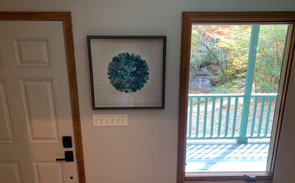 Artwork and view of waterfall as you come down the steps from upstairs