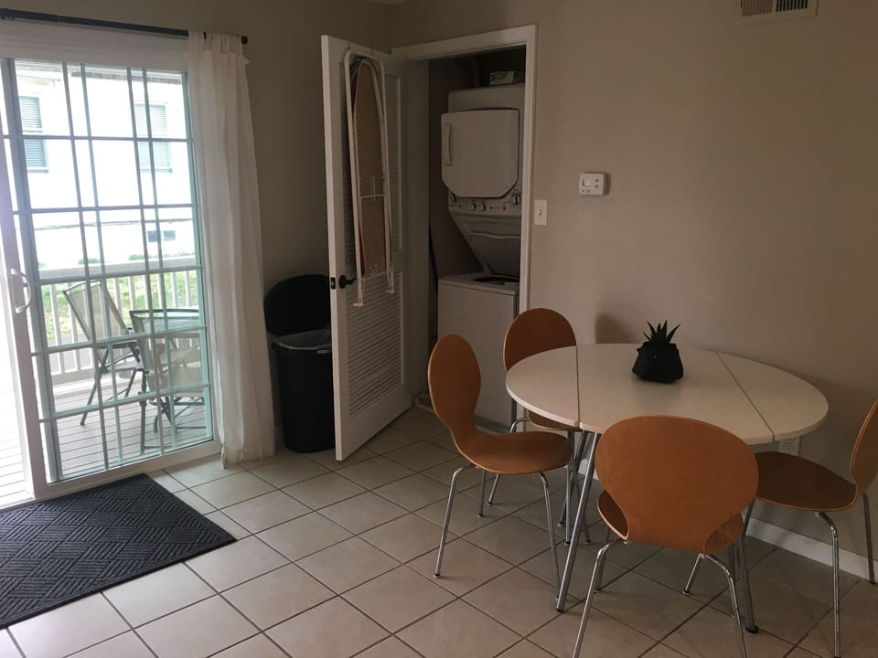 Kitchen - table/chairs, washer/dryer and view to covered deck