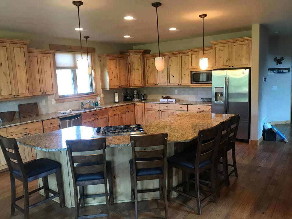 Kitchen fully stocked with cooking supplies and appliances 