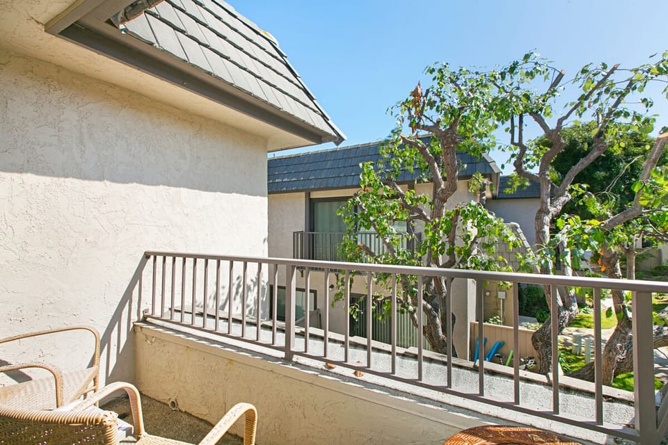 Balcony with chairs off primary bedroom