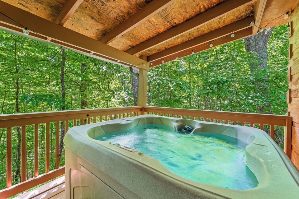 Unwind in your bubbling hot tub under a canopy of trees — stargazing encouraged