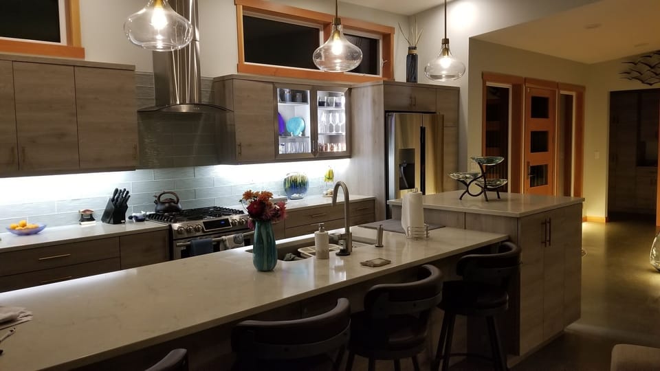 modern kitchen with large counter and expansive waterviews.