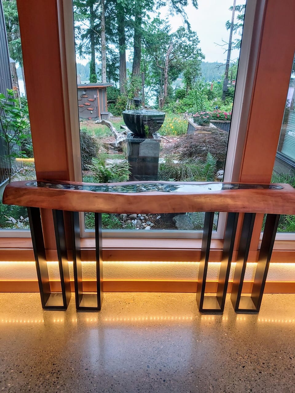 Entryway overlooks garden, fountain and waterway.