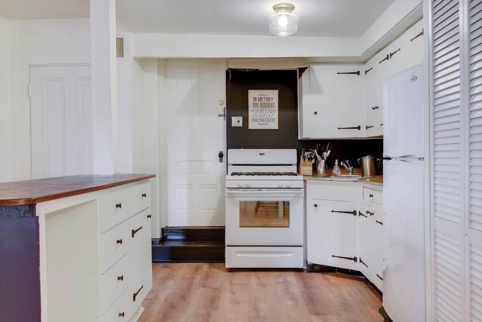 Bright kitchen with classic white cabinets and ample counter space for easy meal preparation.
