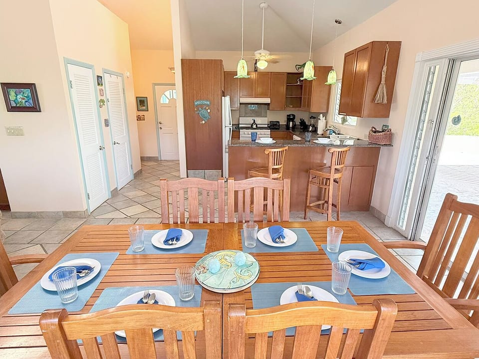 The interior dining table and kitchen occupy the west end of the great room