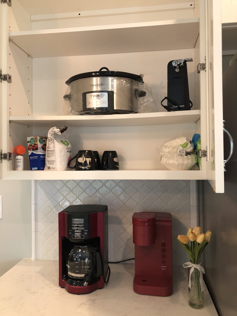 Keurig and regular coffee maker in full kitchen.