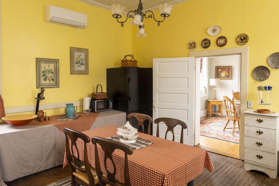 Dining option with second option and kitchen in background.