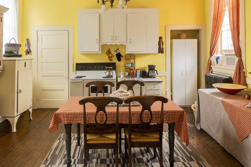 Dining option with second option and kitchen in background.