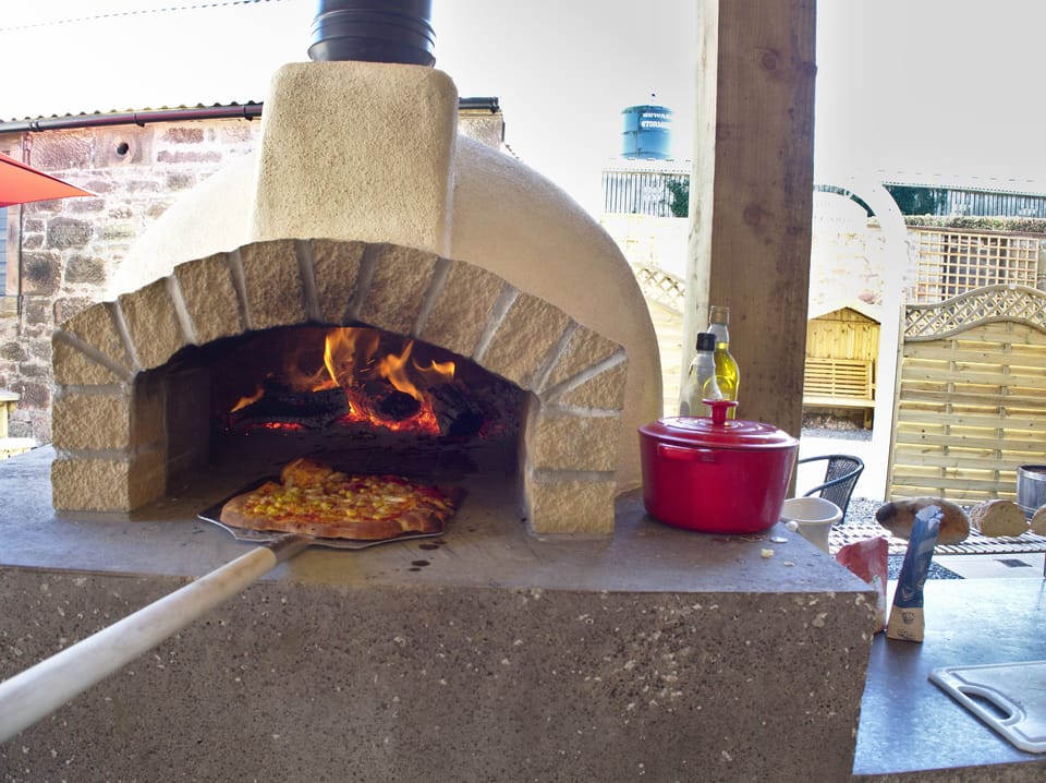 Wood fired pizza oven which is an experience cooking pizza, bread, veg or meat.