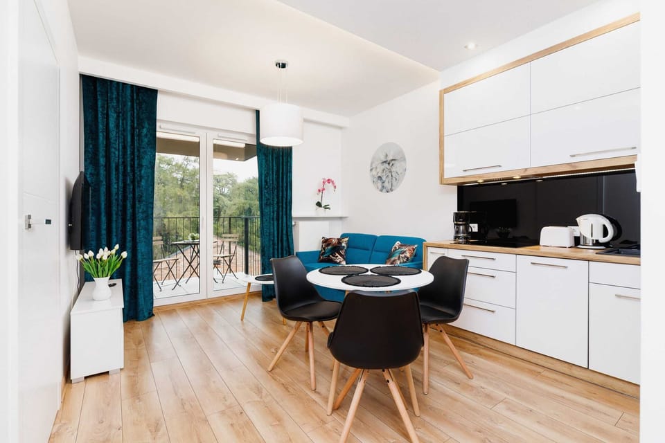 A wide-angle view of the open-plan living and dining areas, showing their connection.