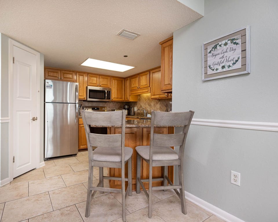 Gather around the breakfast bar with two stools, perfect for casual meals in this inviting kitchen space
